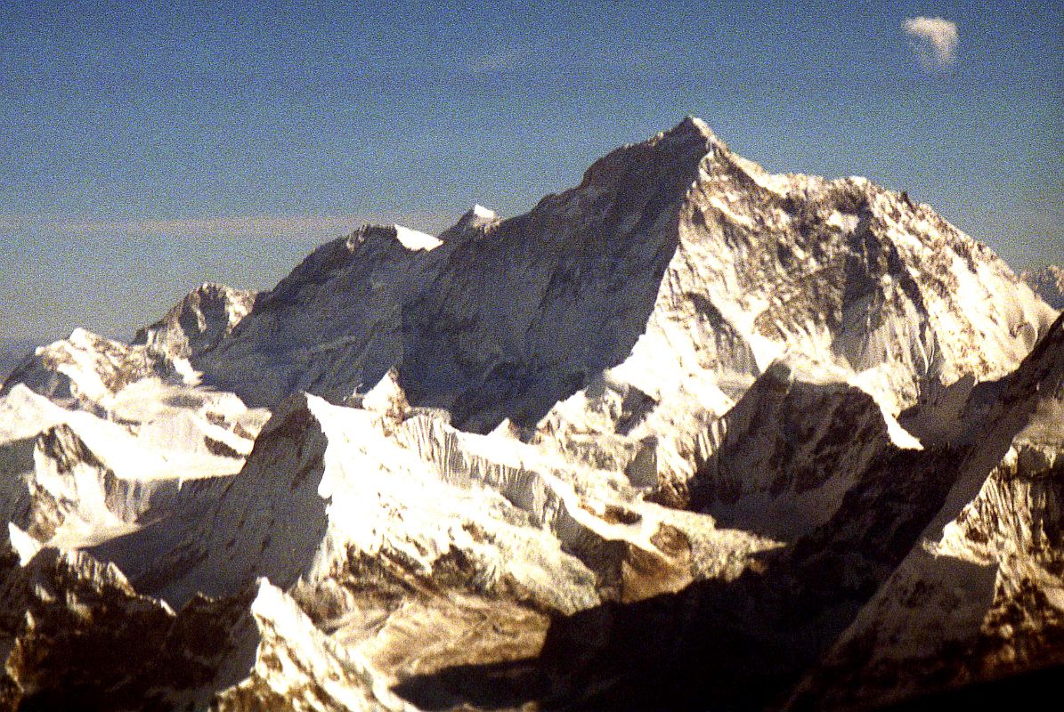 Kathmandu Mountain Flight 09-2 Makalu 1997 The massive west face of Makalu (8462m) is seen from the Kathmandu Mountain Flight. The ridge in the centre of the photo is the exceedingly difficult, very steep Makalu West Pillar. Kangchungtse (7678m, also called Makalu II) is on the left.